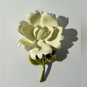 Vintage enamel white flower with green stem brooch.